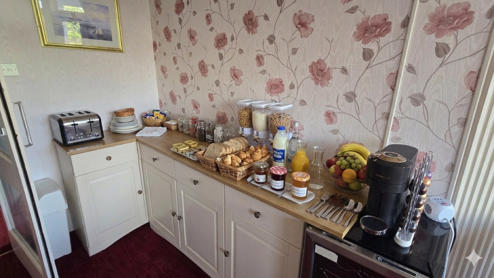 Breakfast buffet — fresh bread, fruit, juice, jams, and Nespresso