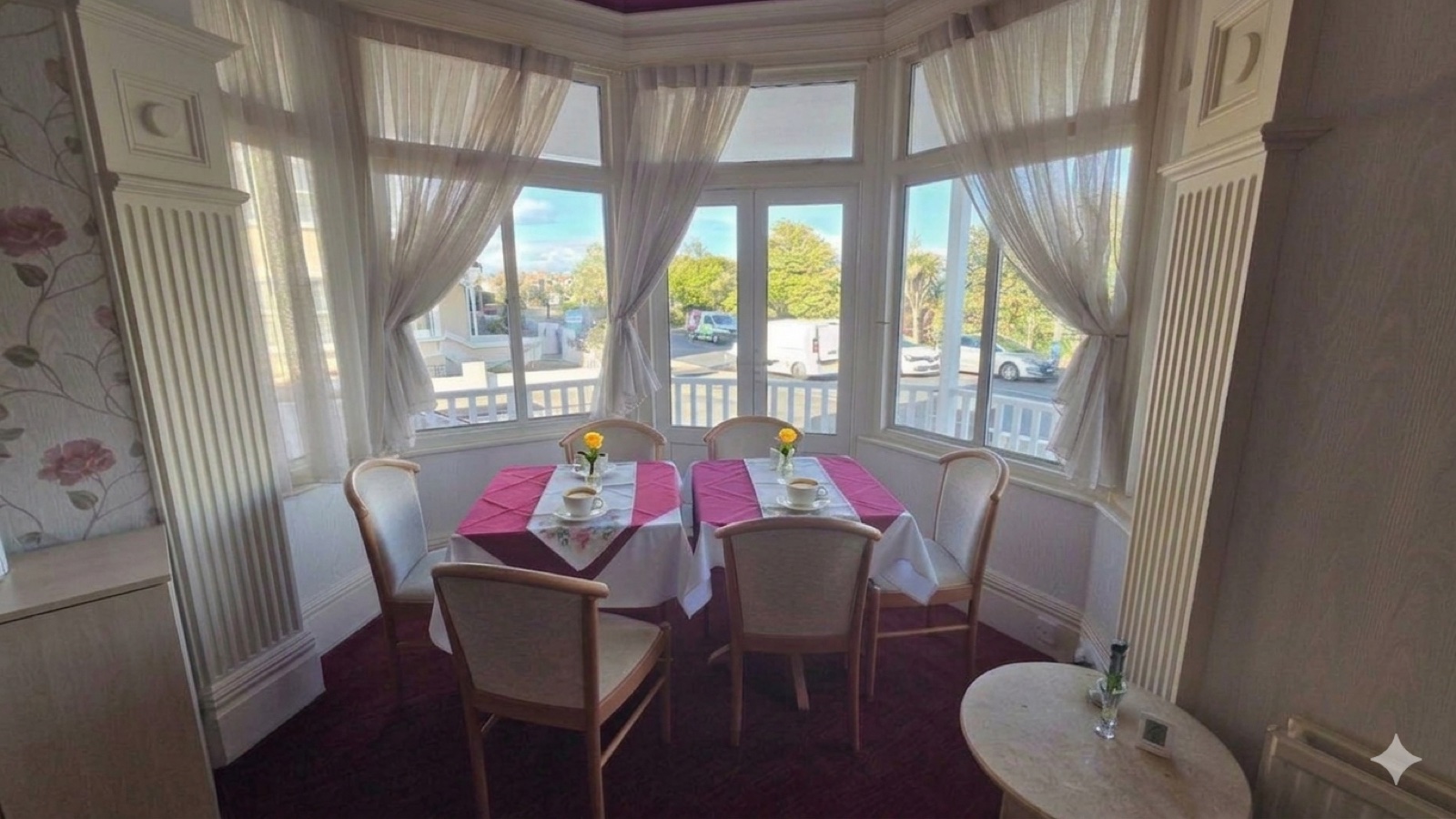 Our signature Atlantis Lounge — bay window seating with Royal Parade views