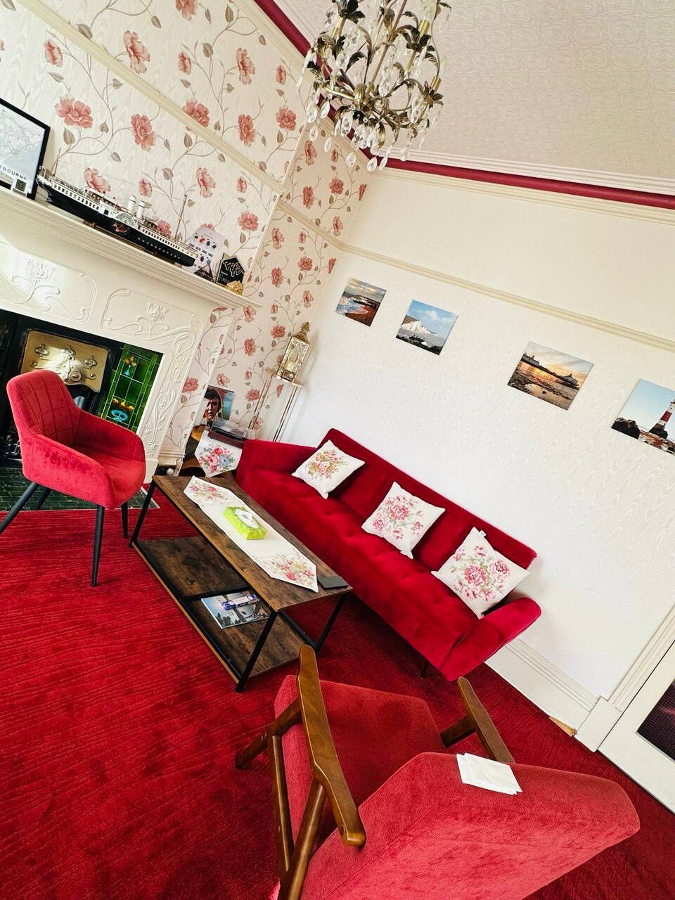 Guest lounge — armchairs and coffee table beside the fireplace