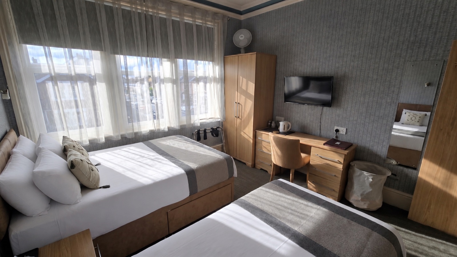 Tourmaline room — twin beds with TV and writing desk
